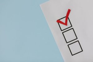A simple white paper checklist with one red checkmark.